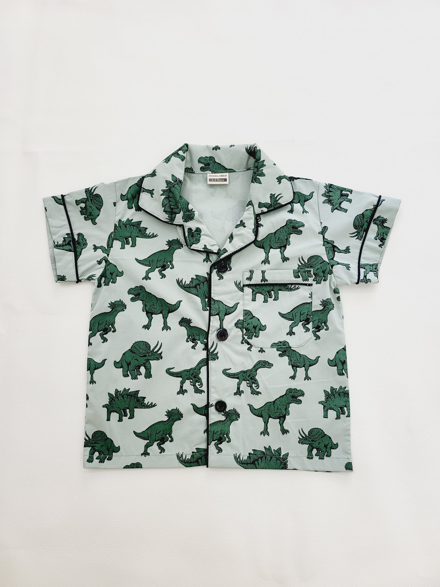 Unisex pyjama nightsuit in green with fun and colorful dinosaur design, ideal for kids who love adventure and play