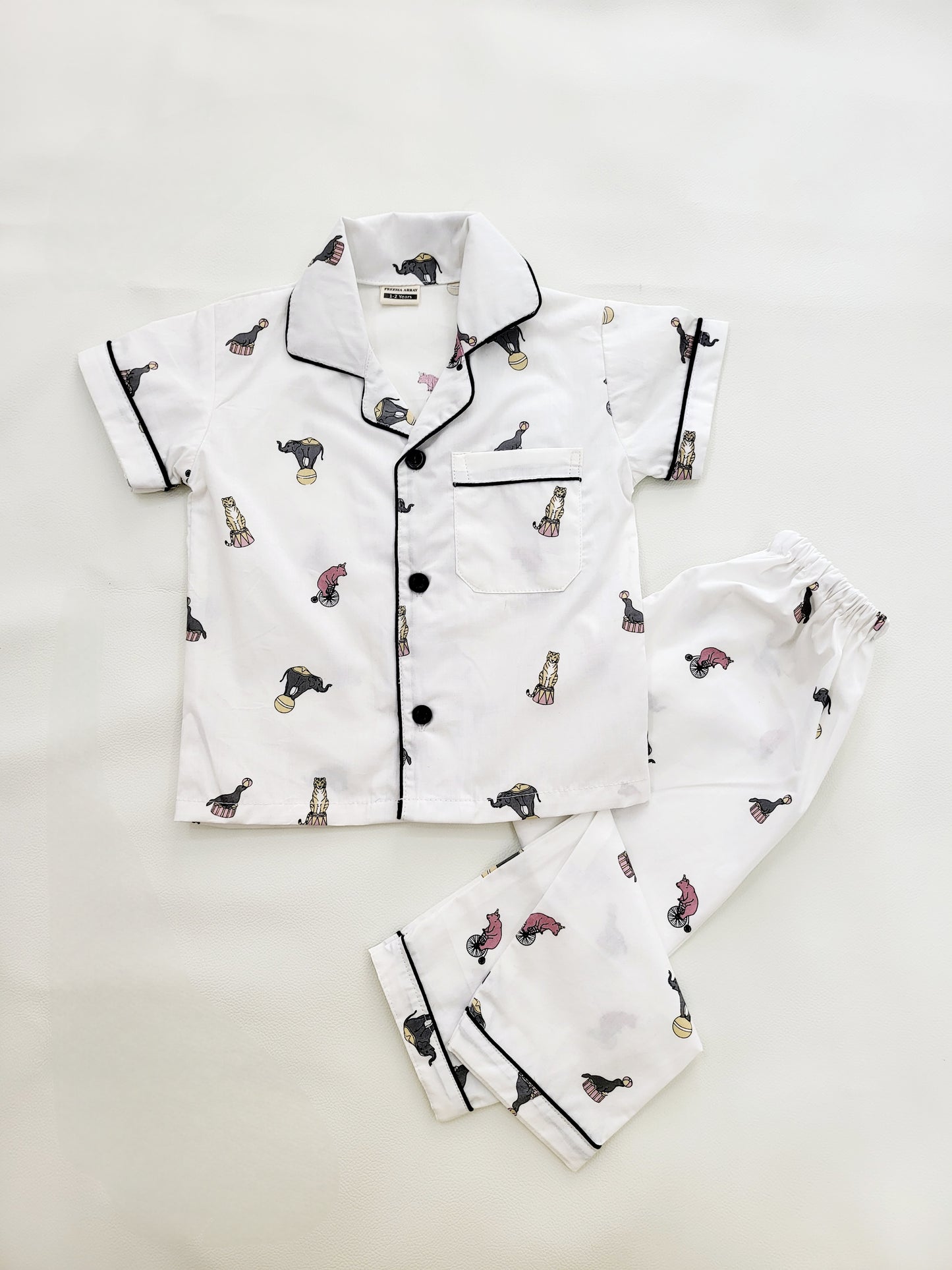 Short sleeve nightsuit with pyjama, made from soft cotton, with a white base and adorable elephant and circus print, ideal for kids' sleepwear