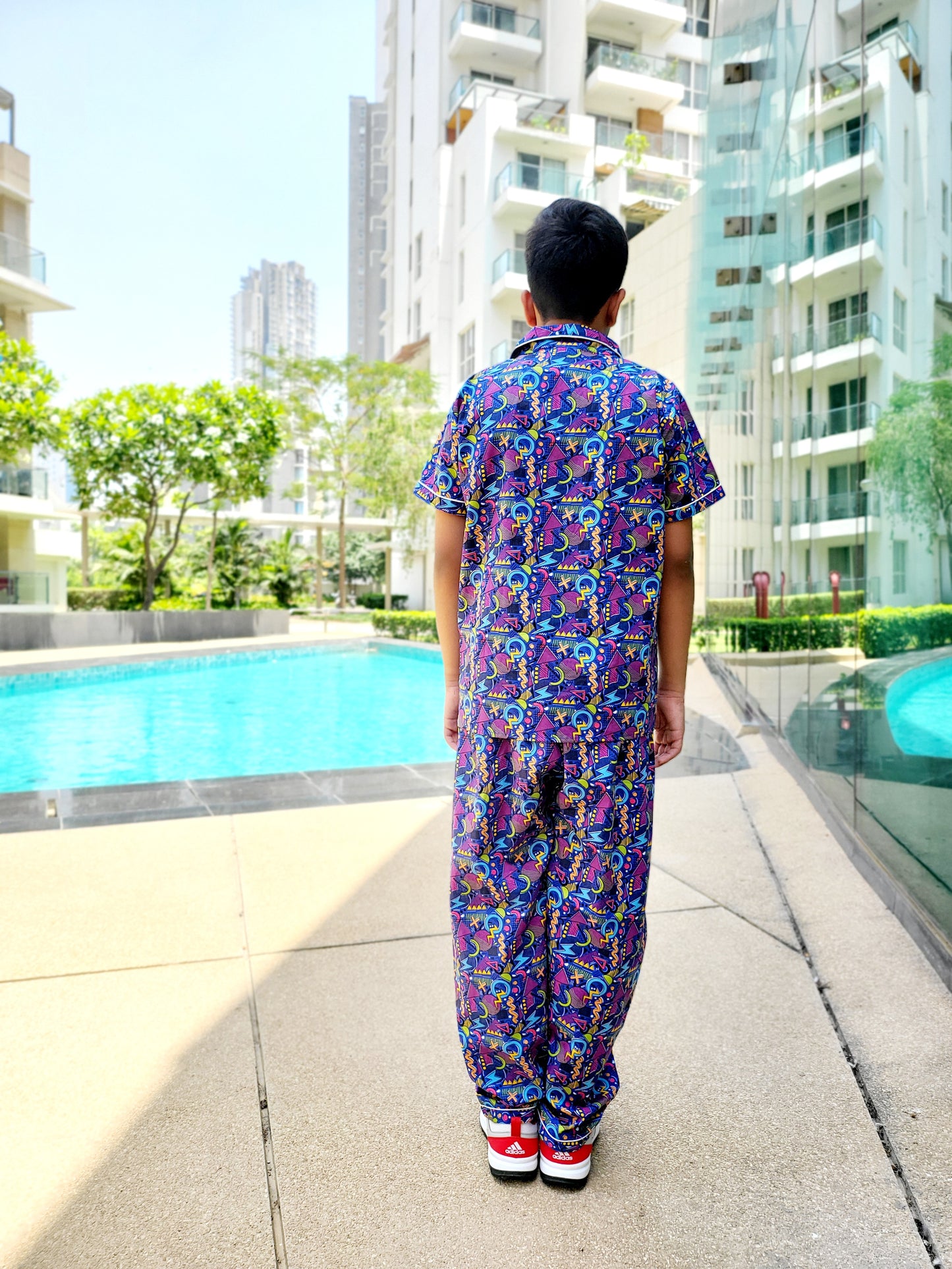 Bright and playful blue unisex nightsuit with geometric electric print in yellow and pink, designed for kids aged 1-14 years, for a fun and comfortable sleep