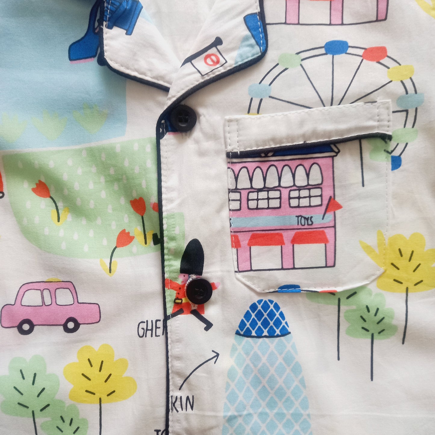 White full sleeve nightsuit for kids with a fair print, featuring wheels and cartoon characters, a fun and cozy sleepwear option for bedtime, made from soft and comfortable material"