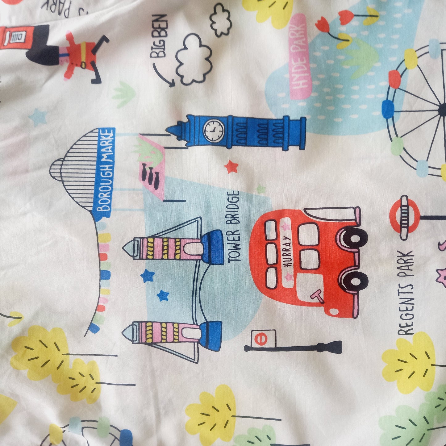 White unisex nightsuit with full sleeves, featuring a fair theme with wheels and cartoons, a great way to encourage kids to have fun and be playful, even at bedtime