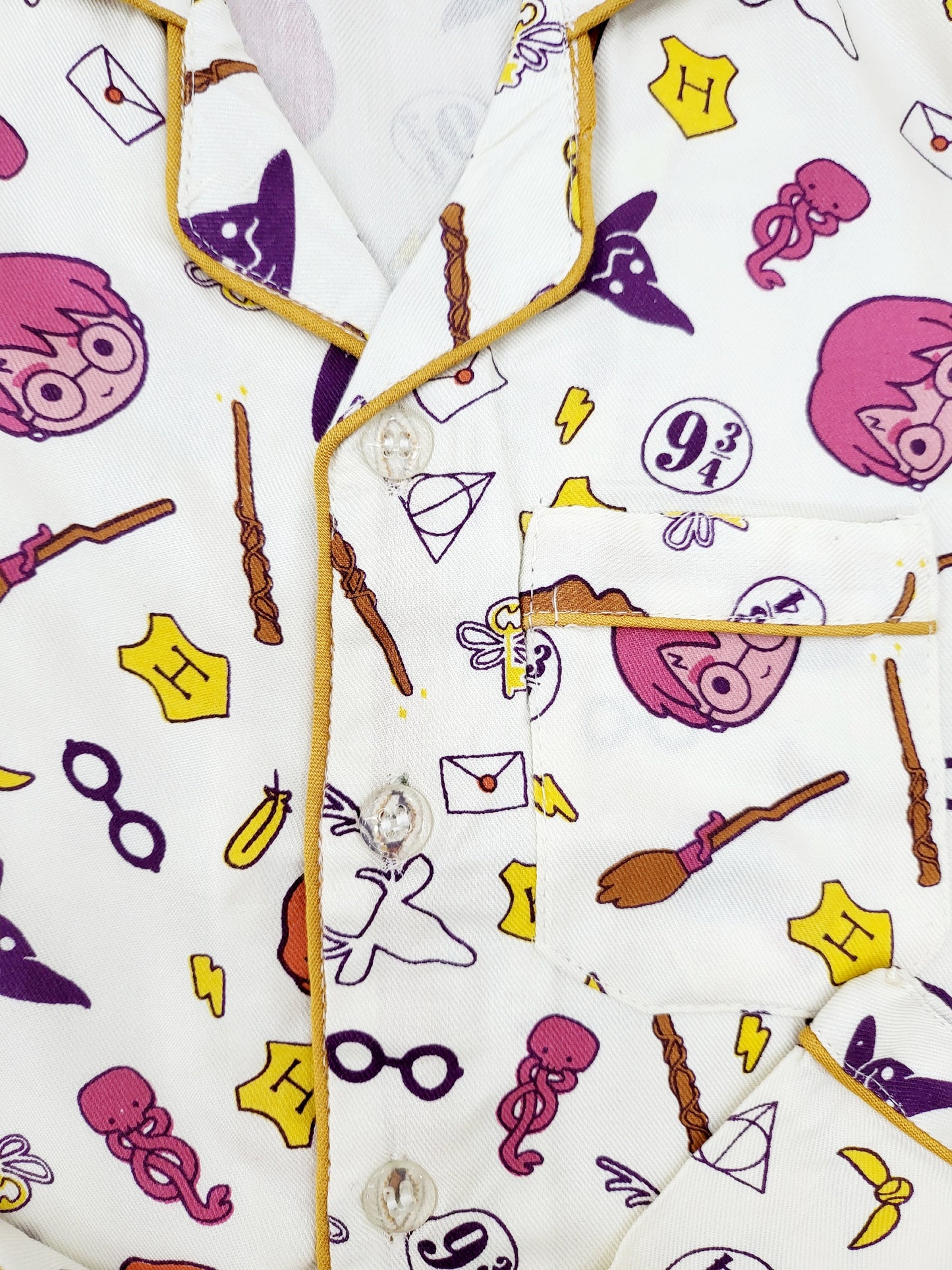 Close-up of the Hogwarts crest on the front of the Harry Potter nightsuit, featuring the iconic symbols from harry porter book, made from high-quality cotton