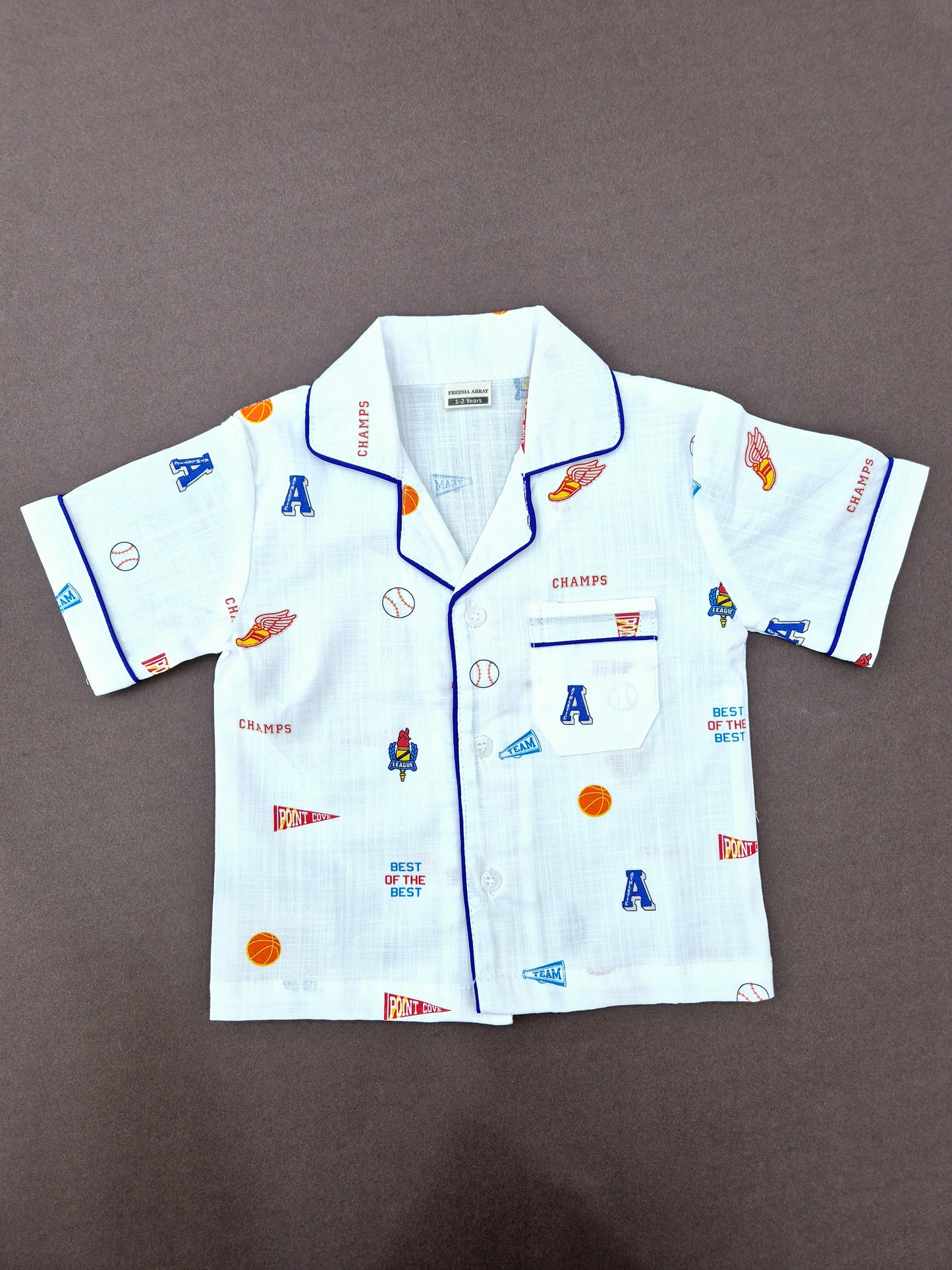 Comfortable white kids' sleepwear set with sporty rugby graphics and bold 'CHAMP' lettering – unisex design.
