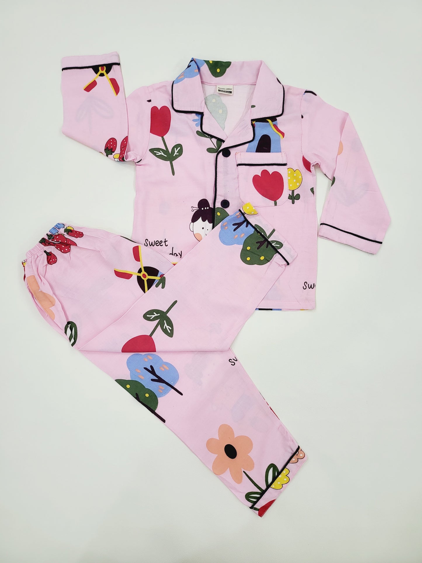 Pink nightsuit with colorful doll print, featuring a fun and playful design, perfect for kids who love dolls and adventure