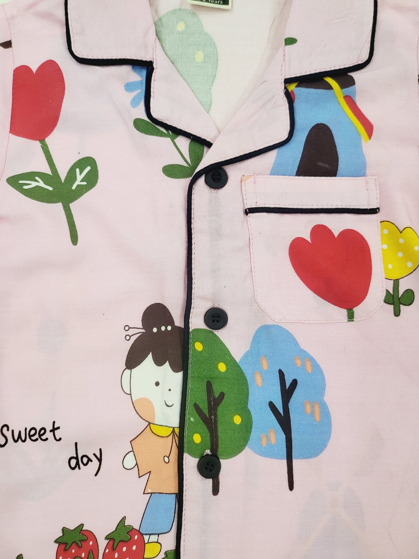 Colorful doll print nightsuit in pink, featured in a flat lay style, highlighting the unique and playful design, perfect for kids who love dolls and fantasy